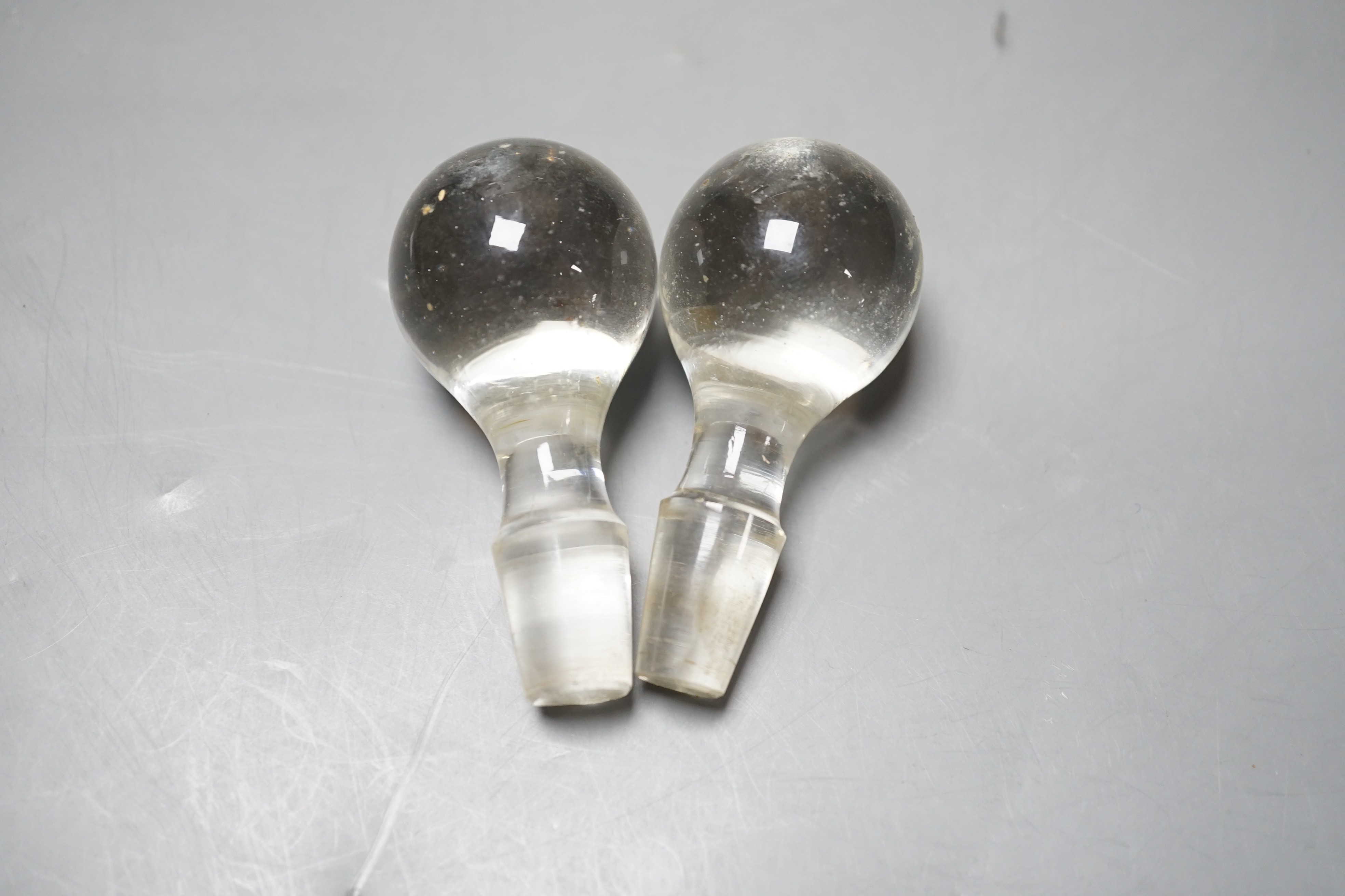 A pair of Edwardian silver mounted hourglass shaped glass decanters with stoppers, by William Hutton & Sons, Birmingham, 1903, overall height 27.5cm.